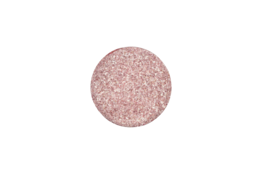 Pink speckled round pill shown in macro detail. This tablet represents medicine for women's health, children's vitamins, or other specific treatment, isolated on white background with clipping path.