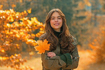 Woman with autumn leaves. Woman near autumn fall leaves in park. Girl on autumnal fall background. Foliage, falling leaves background, autumn leaf and people concept. Autumn portrait.