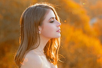 Autumn woman portrait in autumn fall park. Sexy woman with fall leaves. Portrait of beauty model in...