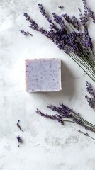 Lavender sprigs surround handmade soap bar upon a textured off white surface, providing natural aromatherapy