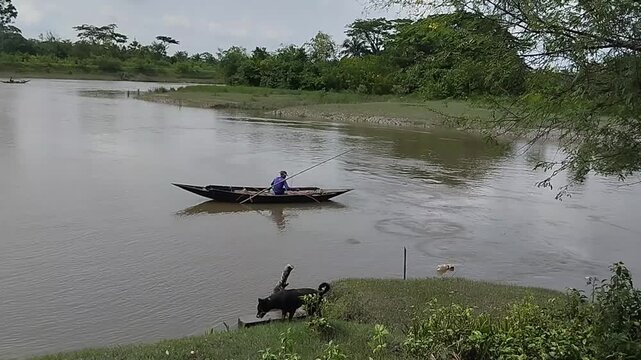 Fisherman with Longline Fishing from Boat in Remote Village Canal, Rural Lifestyle Scene, Peaceful Countryside Moment, Traditional Fishing Method, 4K Still Image
