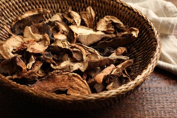 Dried chanterelle mushrooms on wooden table, closeup