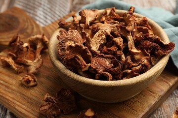 Dried chanterelle mushrooms on wooden table, closeup