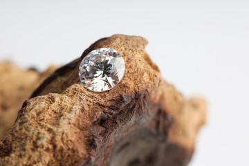 One beautiful shiny diamond on wood, closeup