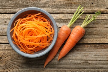 Raw beetroot noodles and fresh vegetables on wooden table, flat lay. Vegetarian dish