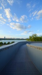 Fototapeta premium Modern Pathway Overlooking Serene Lakeside Cityscape