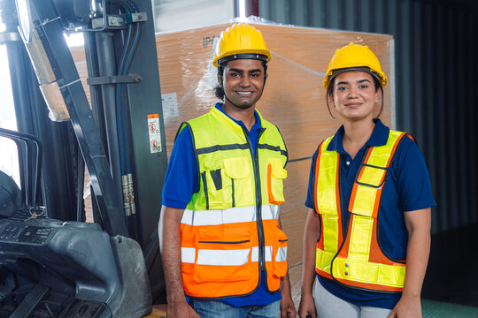 Diverse workfoce team black men,woman factory worker wear safety helmet, safety vest use tablet for industrial warehouse job.Teamwork efficient success modern logistic manufacture operation management