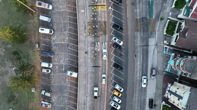 Aerial top down view of peloton cycling Bondi Beach main road by ocean early morning Sydney Australia