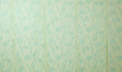 Old wallpaper on the wall. Old wallpaper for texture or background.