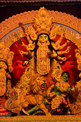 Howrah, West Bengal, India- 11.10.2024 : Beautifully decorated Durga idol is being worshipped inside puja pandal. Durga Puja is biggest festival of Hinduism, celebrated all over the world.