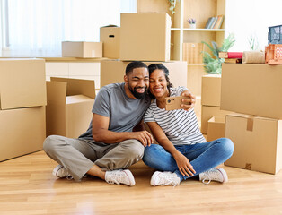 Portrait of a young couple unpacking, moving in and relocation to a new apartment, happy young...