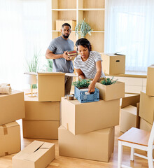 Portrait of a young couple unpacking, moving in and relocation to a new apartment, happy young...