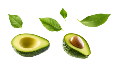 Sliced avocado halves with seed and green leaves, isolated on a white background — fresh and natural