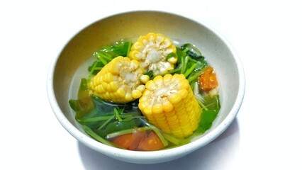 Spinach Clear Soup with Corns. Sayur bening bayam jagung served in white bowl, Indonesian popular food 