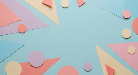 Abstract composition of pastel colored paper shapes including triangles and circles arranged on a light blue background, creating a playful and modern design.