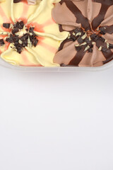 A top-down view shows two sections of swirled ice cream, vanilla with pink streaks and chocolate...