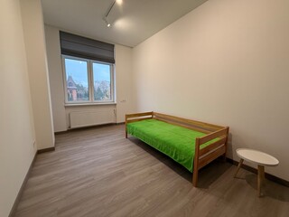 Minimalist Bedroom with Wooden Bed and Large Window