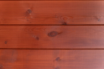 Red painted wooden planks creating a warm and rustic background, ideal for design projects