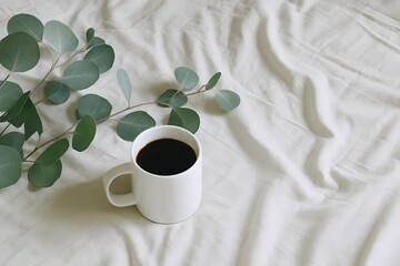 Morning Coffee with Eucalyptus Leaves on Soft White Bed &ndash; Minimalist Lifestyle Scene