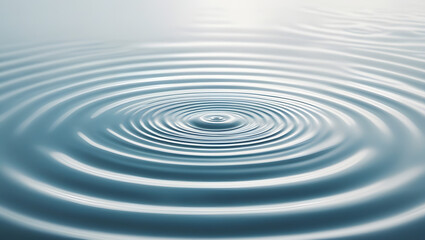 Ripples and water drop creating splash on clear blue surface