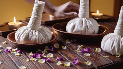 Traditional Thai spa massage tools and wellness accessories arranged neatly on wooden table for relaxation therapy