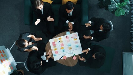 Top down view of smart business people hands making scrum task board to manage workflow in...