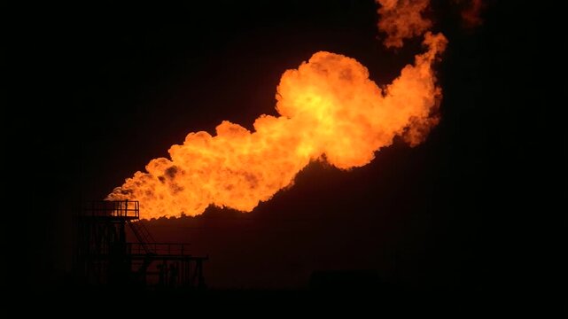 Gas Flare Igniting at Night on a Drilling Rig