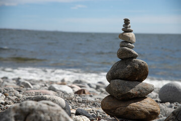Balanced Stone Tower Near the Sea with Gentle Waves