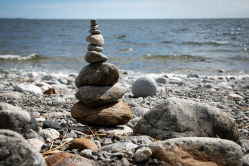 Zen Rock Stack on Pebble Beach with Ocean Waves