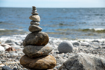 Zen Rock Stack on Pebble Beach with Ocean in Background