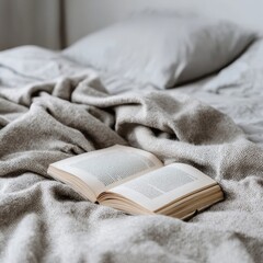 A book on a bed with a blanket
