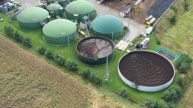 Biogas plant and farm in fields. Renewable energy from biomass. Agriculture prepared for Green Deal. Aerial view to Czech industry. Sustainable development in European Union.	