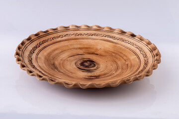 Hand Carved Decorative Ceramic clay plate on white.