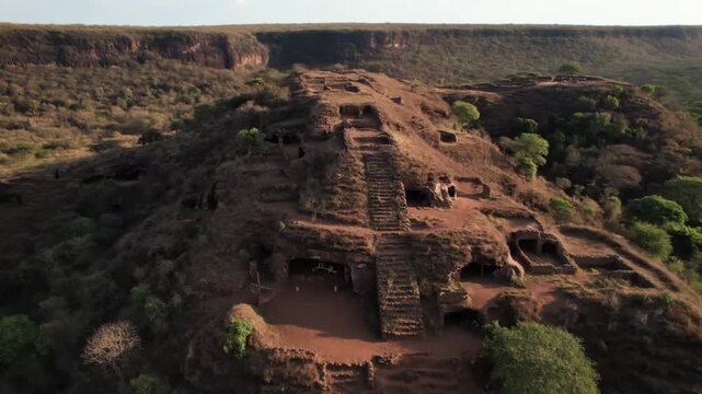 An aerial view captures a prehistoric rock shelter cave in kenya, africa, revealing ancient rock art and the rich cultural heritage of this archaeological site nestled in a rugged landscape