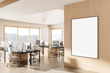 Modern office interior with blank framed poster on wooden wall and minimalist clean workspace...