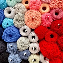 These colorful pictures show a neatly arranged and colorful set of spools and bobbins. The yarn is neatly stacked.
