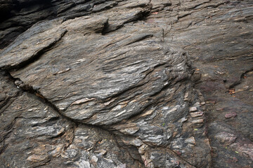 Detail of rock structure. Stone background. Gneiss rock texture. 