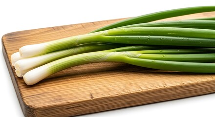 Fresh green onions on a wooden cutting board providing a culinary presentation