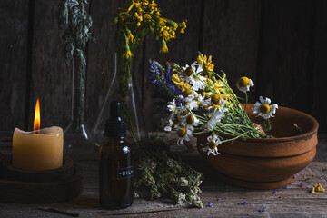Herbal medicine and flowers on a wooden background. Alternative medicine.