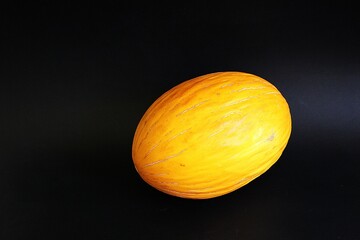 yellow melon, cantalupe melon, fruit on black background, juicy fruit