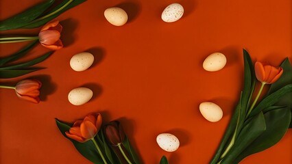 Easter eggs and orange tulips on burnt orange background; minimalist spring flatlay.