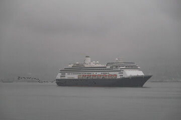 Classic cruiseship cruise ship liner Zaandam arrival into Vancouver, Canada port on grey foggy...