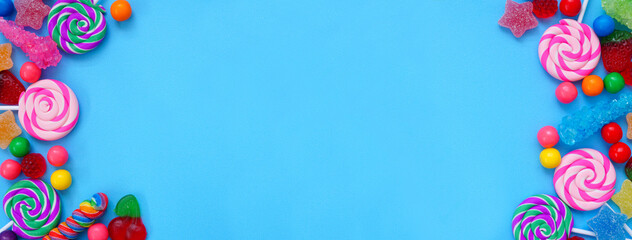 Colorful group of candies. Top view double border over a blue banner background.