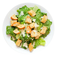 Traditional Caesar salad with croutons and parmesan cheese on a white plate isolated on a white background
