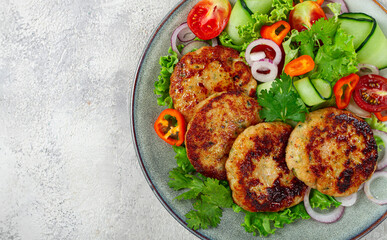 fried chicken cutlets, minced chicken, with vegetables, on gray , with vegetable salad, top view, homemade, no people,