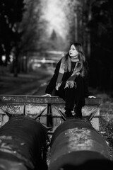 Portrait of a young beautiful long-haired girl in the early winter outdoors. Black and white photo.