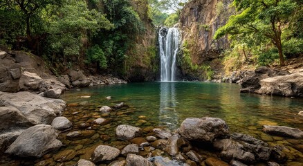 Fototapeta premium A majestic waterfall nestled between cliffs and lush vegetation. Enchanting and breathtaking scenery. The water is crystal-clear, capturing the beauty of nature.