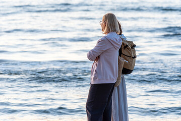 The women walking on a sandy beach at evening. Poland, Baltic Sea during summer time.