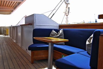 Outdoor promenade boat sun deck onboard modern luxury cruiseship cruise ship yacht liner with teak...