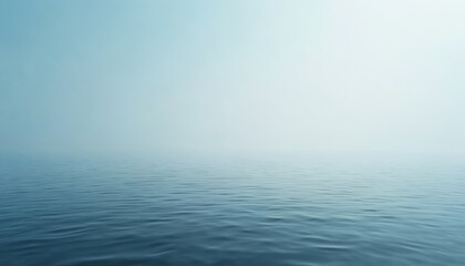 Obraz premium Calm ocean water surface meets hazy sky, creating a vast, expansive horizon. The blue sea shows subtle ripples under soft daylight, offering a peaceful, tranquil, and minimalist natural scene.
